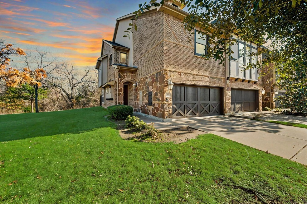 View of front of house featuring a yard, garage and access to walking trail
