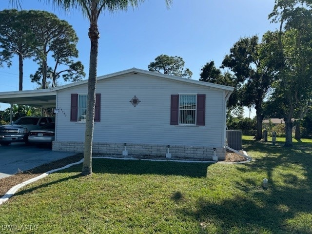 View of front of property with a carport, cooling