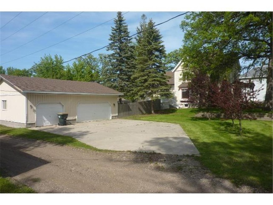 Large concrete driveway leading to the huge garage