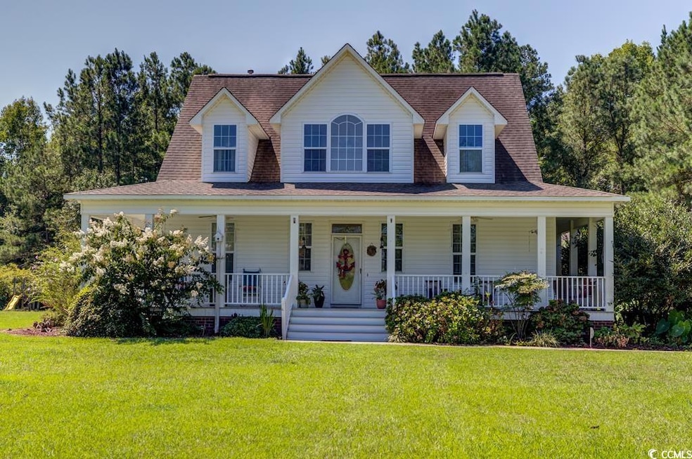 Farmhouse featuring a front yard and a porch