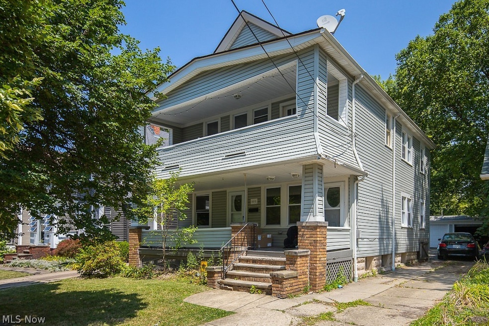 View of front of property with covered porch and a front yard