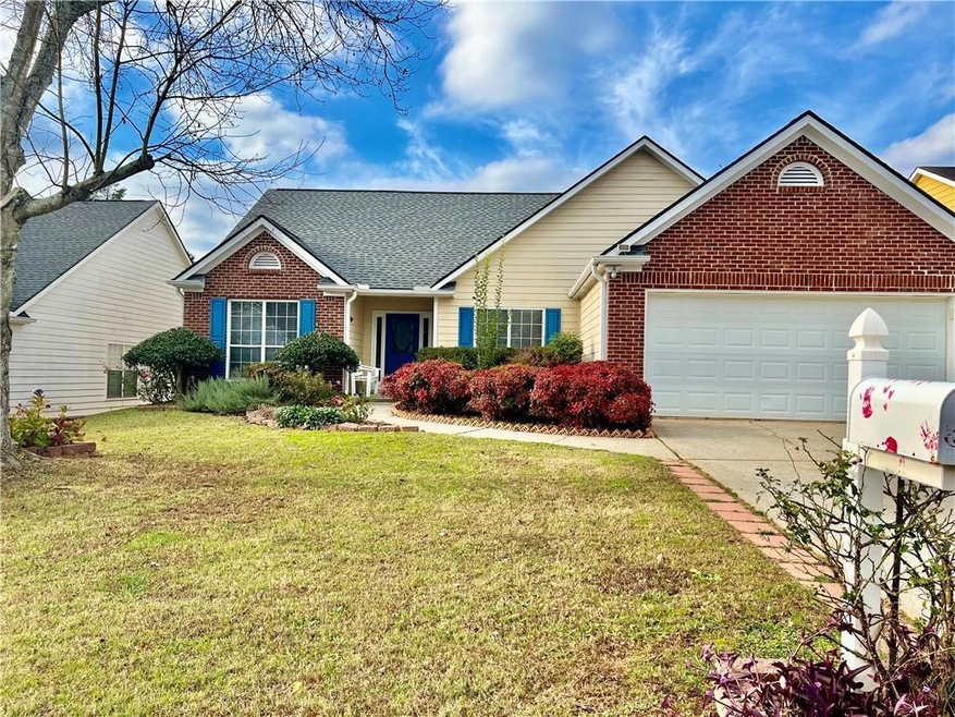 View of front facade with a garage and a front lawn
