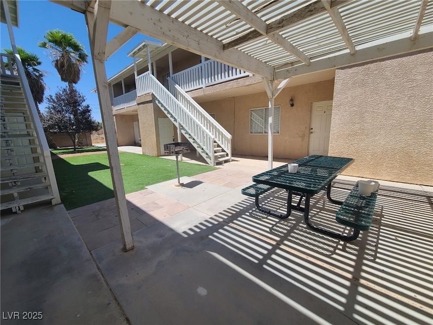 View of patio with a pergola and stairs