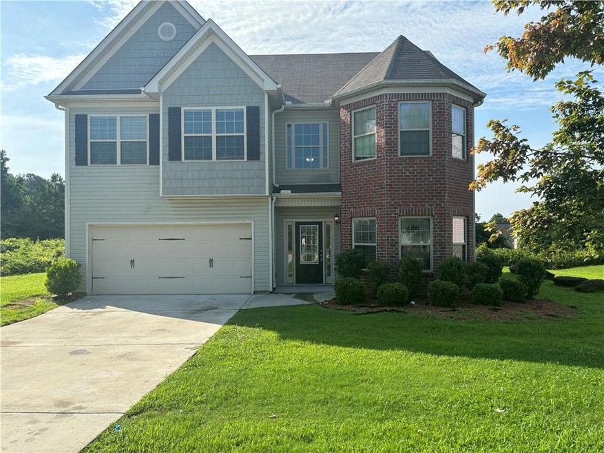 View of front of home featuring a garage and a fro
