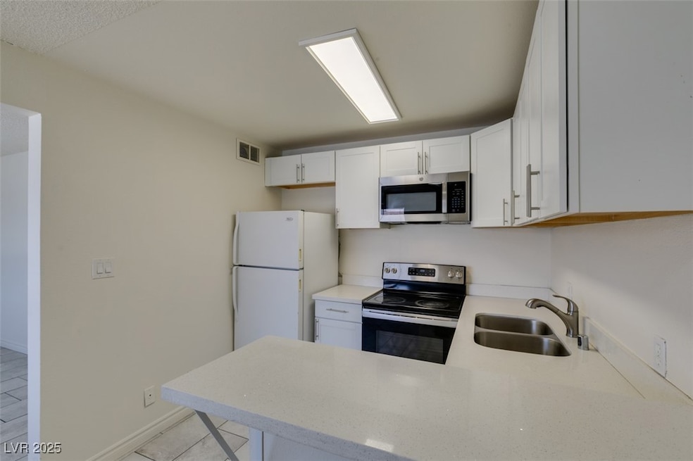 Kitchen featuring stainless steel appliances, a si