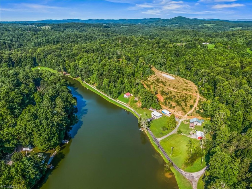 View overlooking the cabin, building site, and lake. 6 acre parcel extends to the far end of the lake.