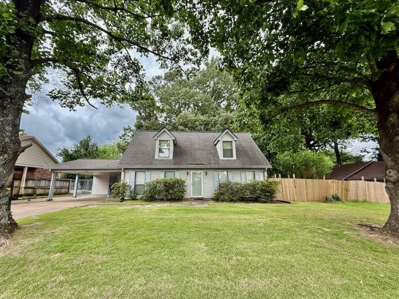 Cape cod home featuring an attached carport, driveway, and a shingled roof