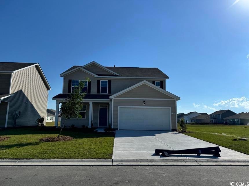 Front facade with a garage and a front lawn
