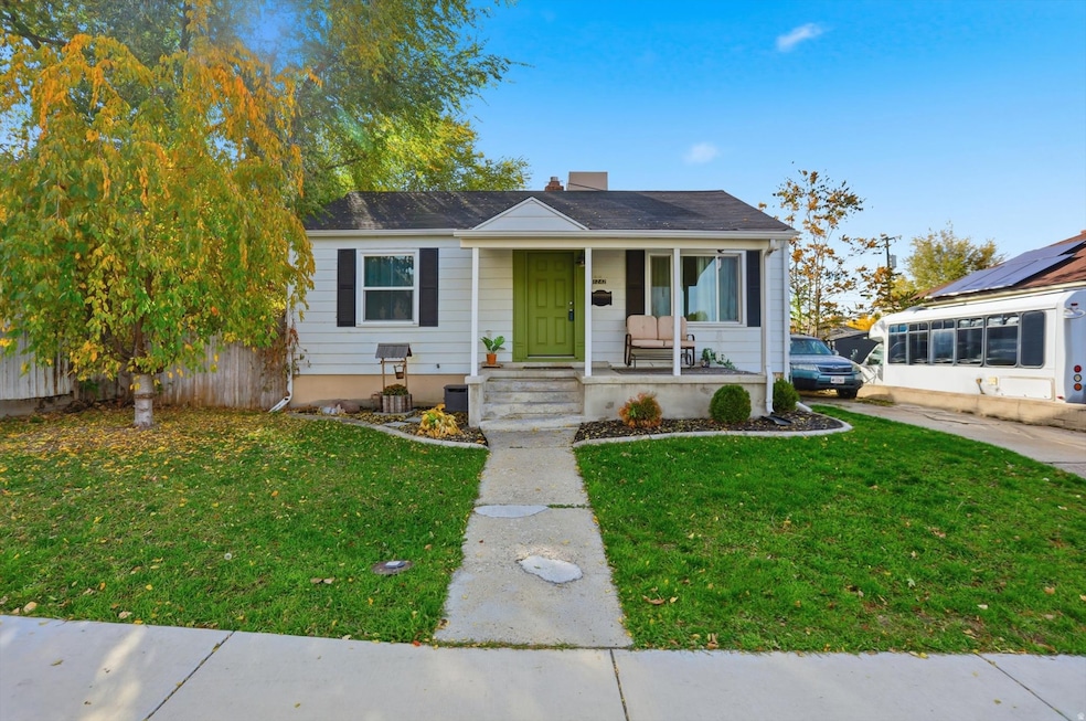 Bungalow-style home featuring a porch, a front yard, and a chimney