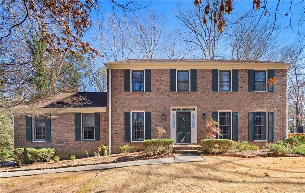 Colonial home featuring a front lawn