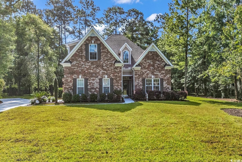 Traditional home with a front yard and brick siding