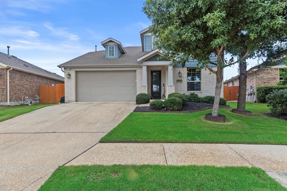 View of front of property featuring a garage, con