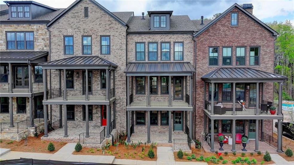View of front facade with a balcony and a patio area