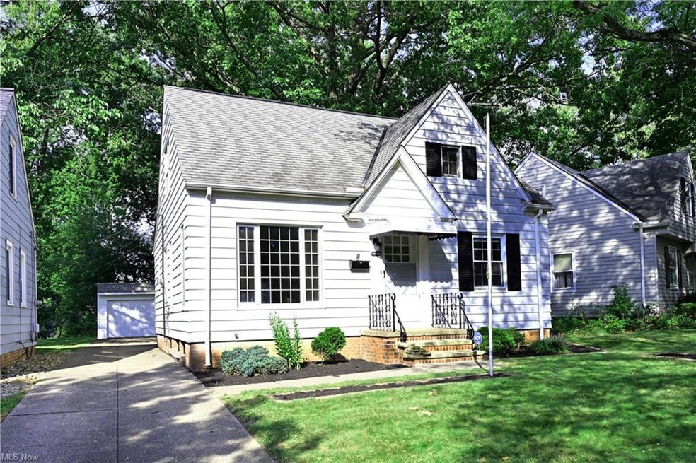 View of front facade featuring a front yard and garage