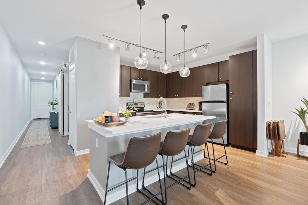 Kitchen featuring light countertops, light wood-t