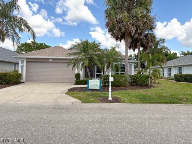 View of front of home with a garage, stucco siding