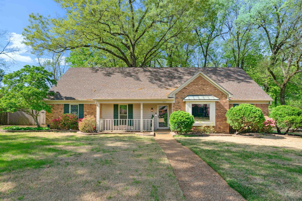 Single story home with a front lawn, covered porch