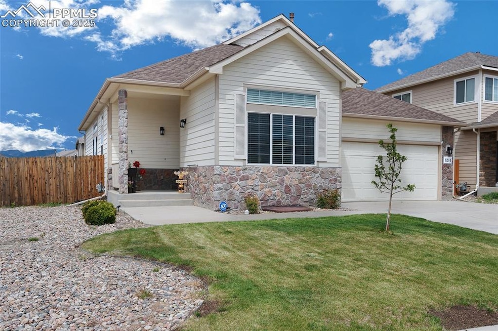 View of front of property featuring an attached garage, a shingled roof, stone siding, and concrete driveway