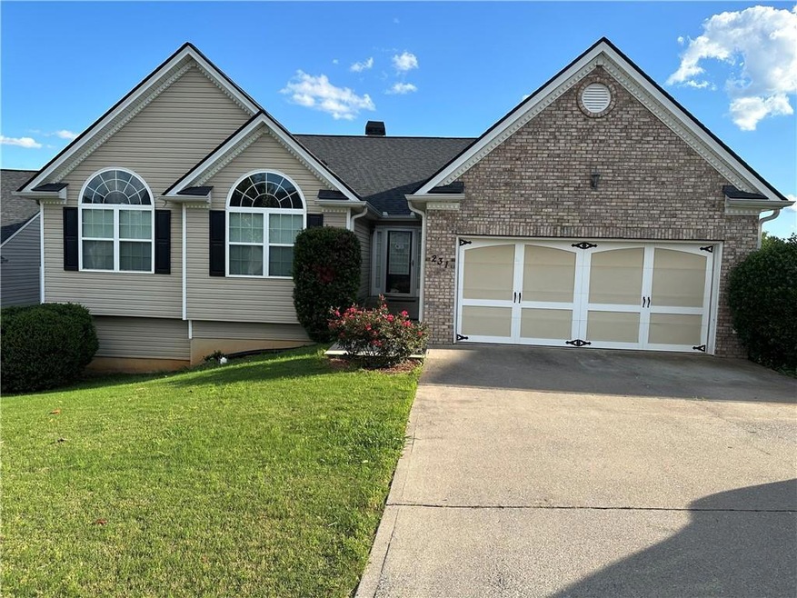 View of front of property with a front yard and a garage