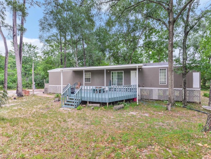 Home features fresh exterior paint,  extended covered wood deck, updated & trailer skirting