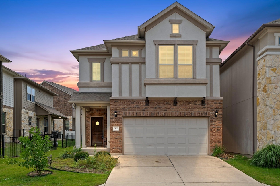 View of front facade featuring stucco siding, a g