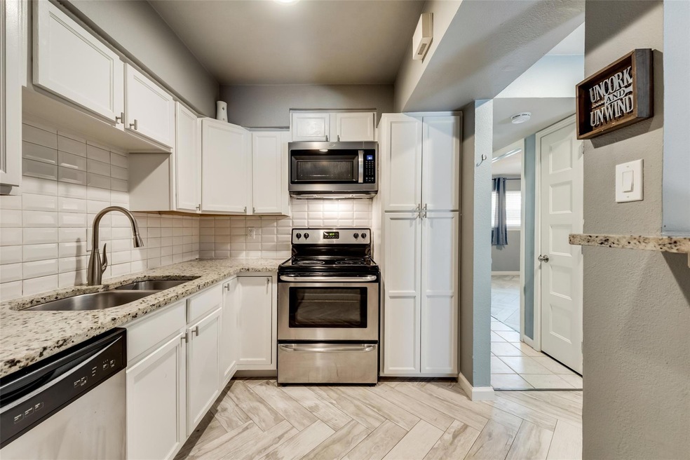 Kitchen with light parquet floors, stainless steel