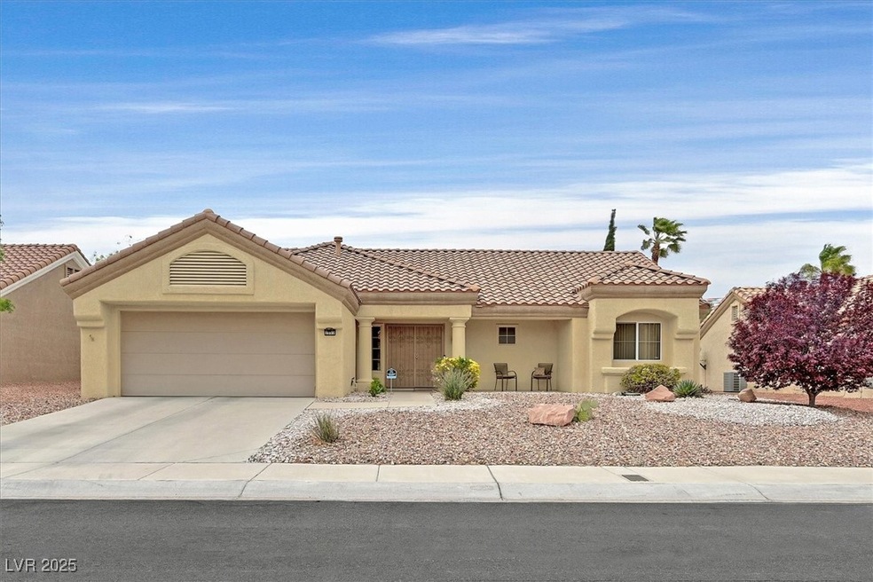View of front of property with a tile roof, an att