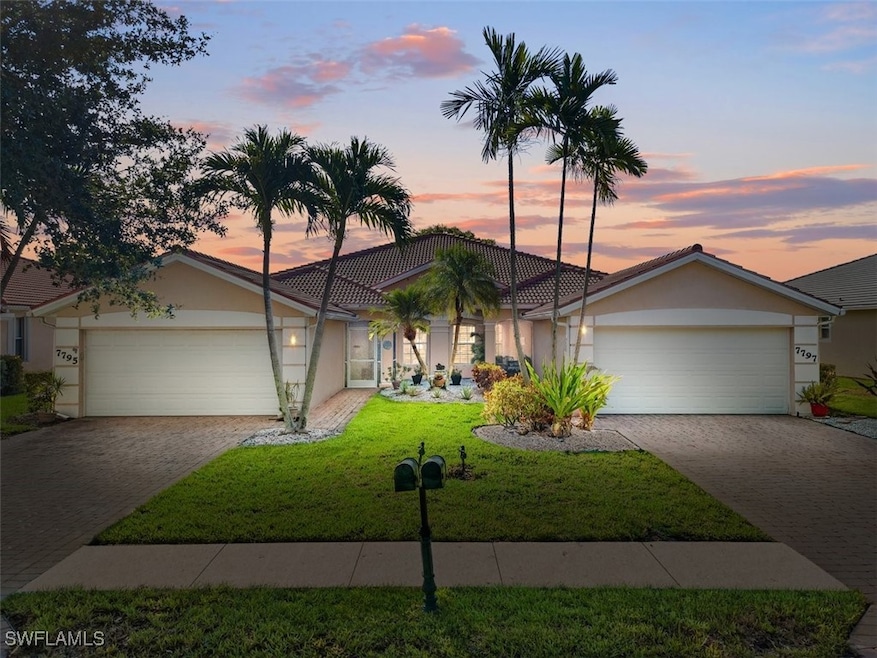 Ranch-style home with a garage and a lawn