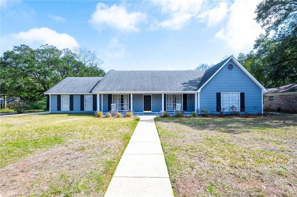 Single story home featuring covered porch, a shing