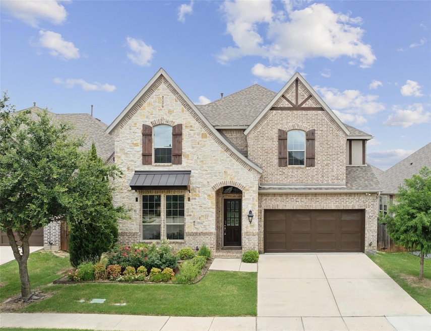 View of front of home featuring a front yard and a garage