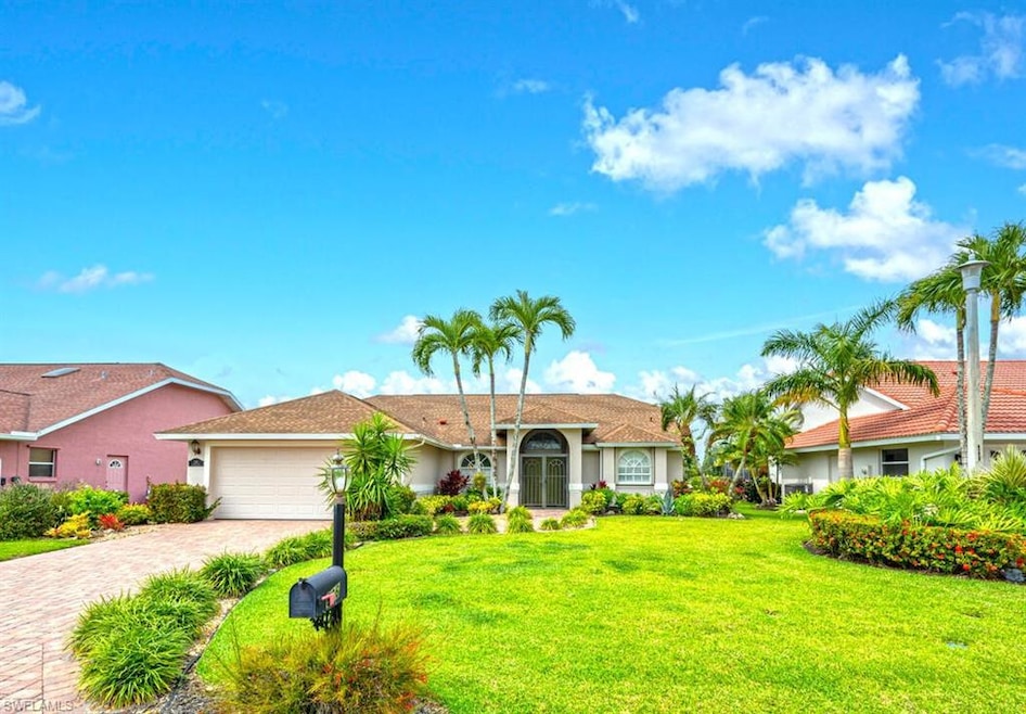 Ranch-style house featuring a garage, decorative driveway, a front yard, and stucco siding