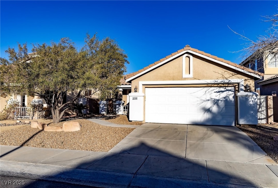 View of front of house with concrete driveway, a t