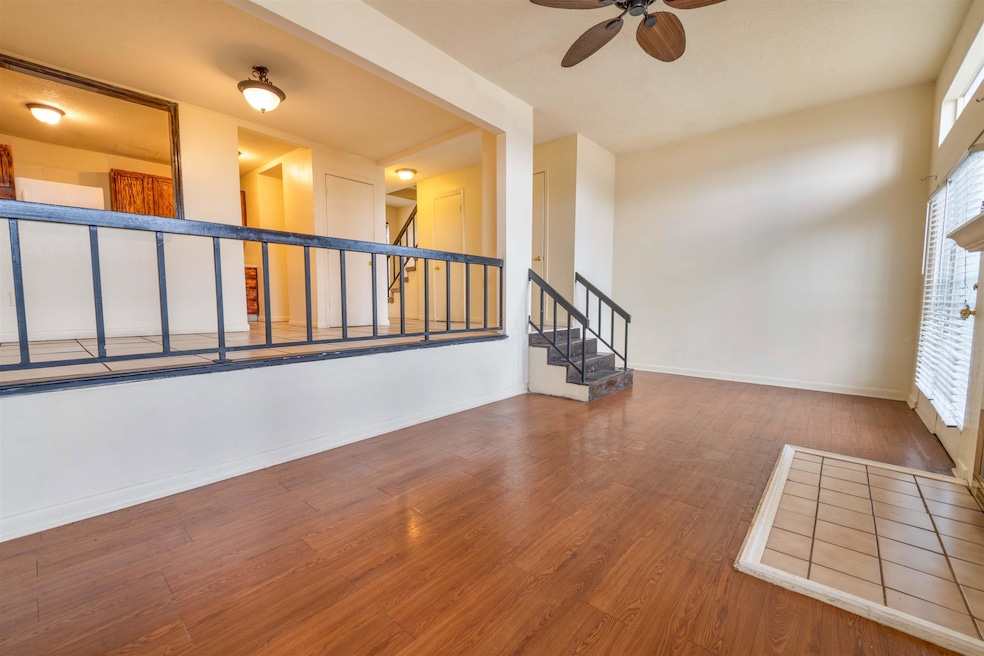 Spare room with baseboards, stairs, ceiling fan, w