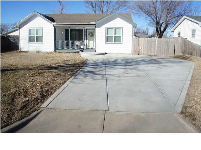 Front of house with extra poured concrete pad on d