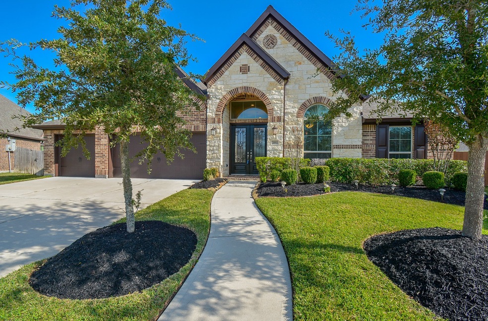 Almost palatial in appearance, this soaring, single story, single family brick and stone 'like new' Perry home is located at 28911 Concan Crossing Court, Katy, TX in the gated, master planned Tamarron community. The home is situated in a lovely cul-de-sac and is MOVE-IN READY!