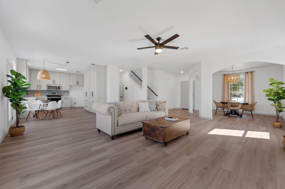 Unfurnished living room with stairs, visible vent