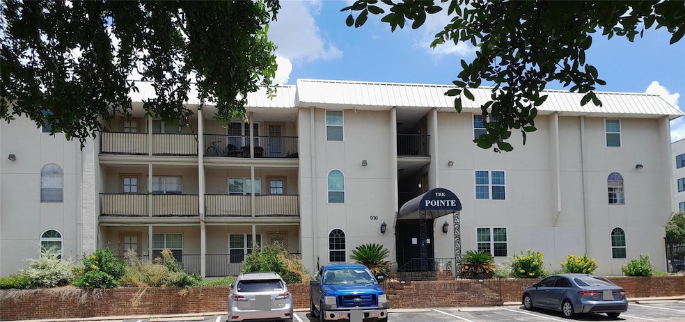 View of building exterior with uncovered parking