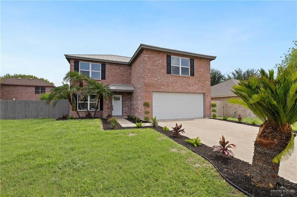 Traditional-style home featuring an attached garage, a standing seam roof, driveway, brick siding, and a metal roof