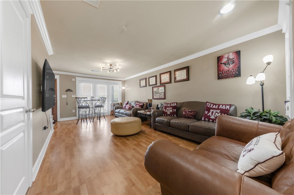 Living room featuring ornamental molding and light