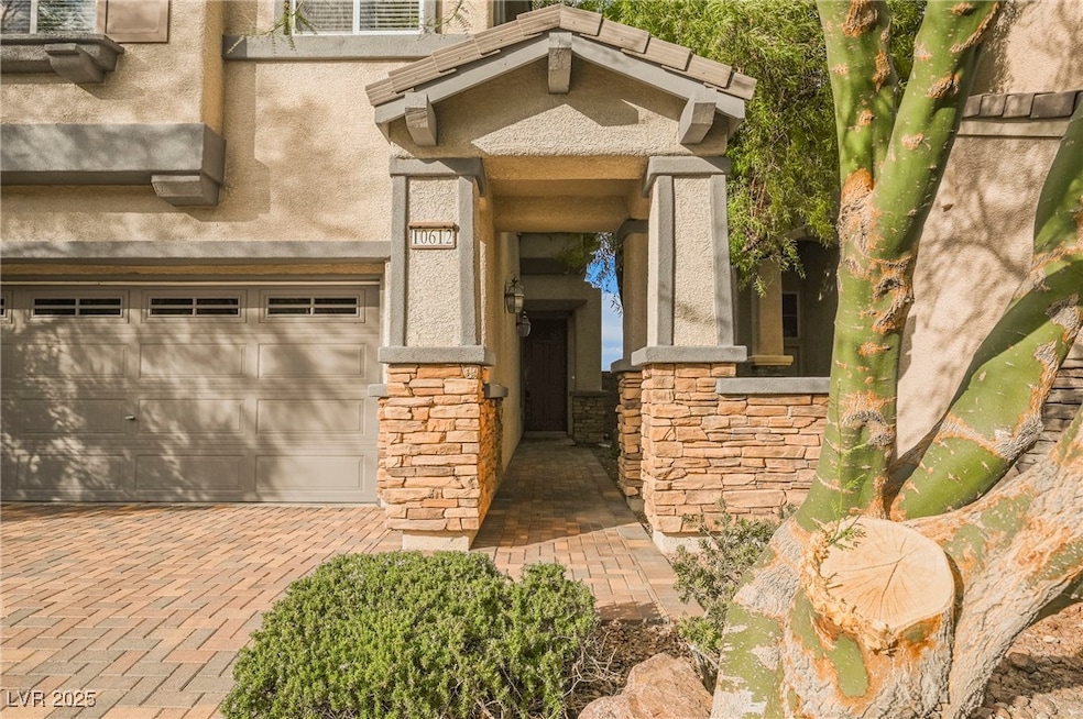View of exterior entry featuring stone siding, an