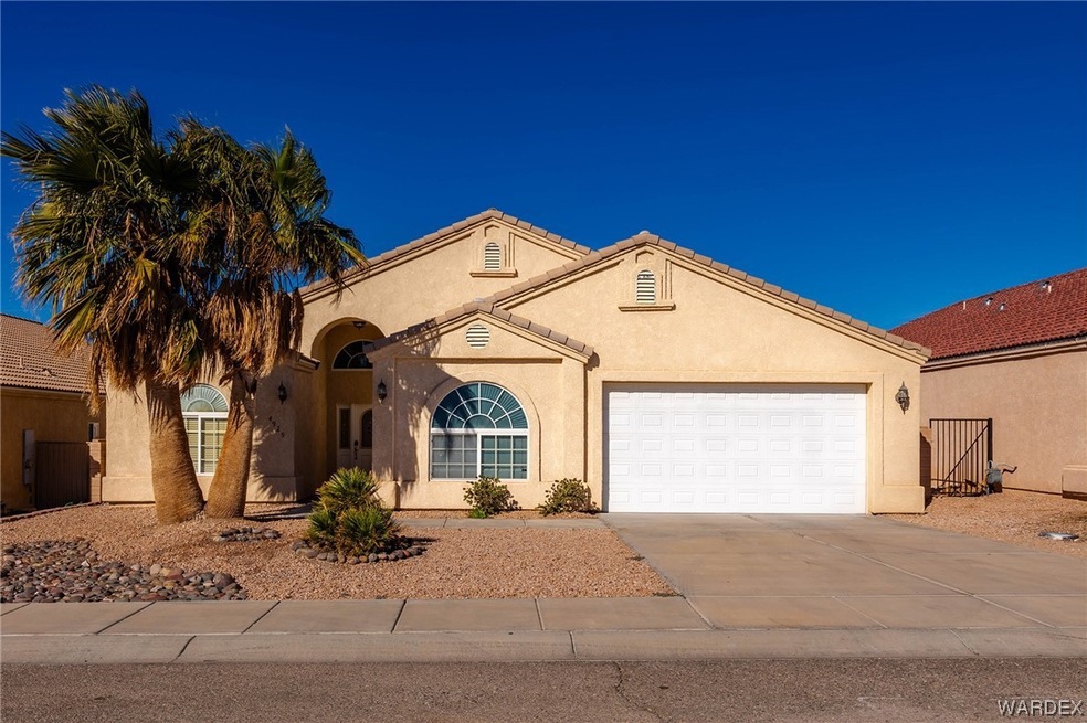 Mediterranean / spanish-style home featuring a gar