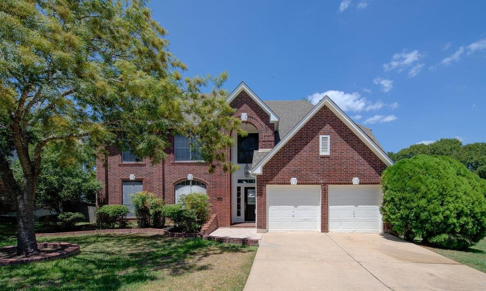 View of front of house with brick siding, drivewa