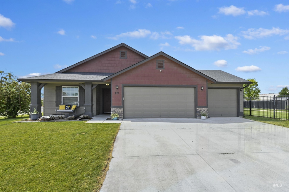 View of front of property with a garage, concrete driveway, roof with shingles, and stone siding