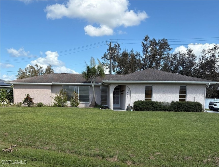 Single story home featuring a front lawn