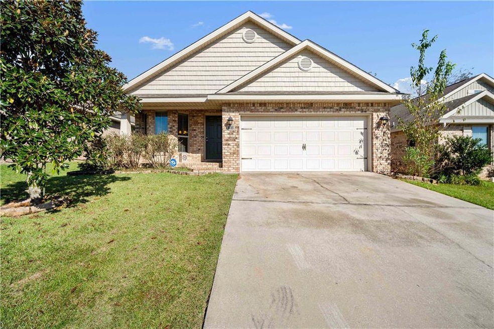 View of front of house with a front lawn and a gar