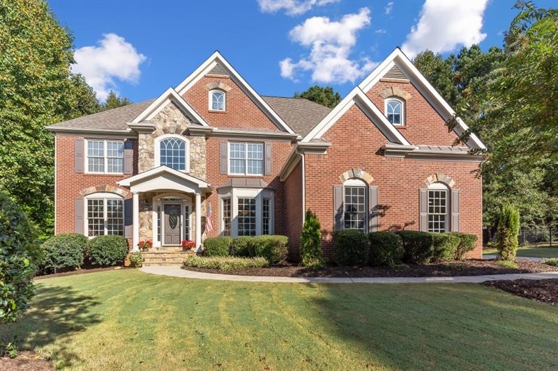 Custom 3 side brick and stone home on large level 