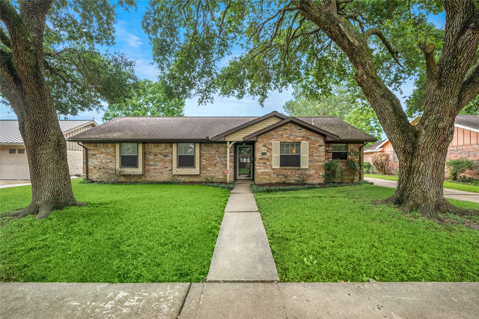 Welcome to 2210 Willow Blvd in Pearland established neighborhood with mature trees.