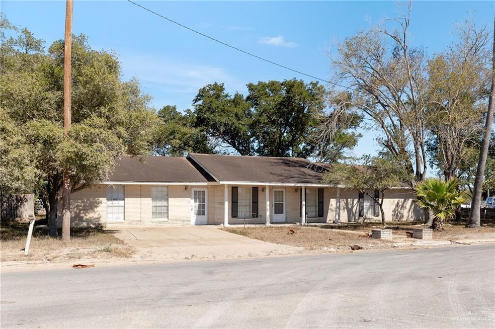Single story home with brick siding and covered porch