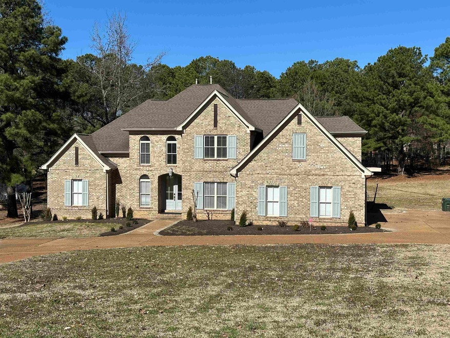 View of front of house with brick siding and a shingled roof
