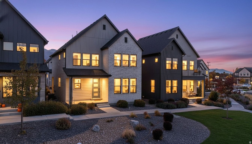 Modern inspired farmhouse featuring board and batten siding and a yard